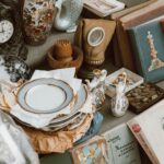A collection of vintage books, ceramics, and antiques displayed in a nostalgic setting.