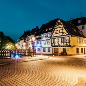 Scenic night view of traditional Alsatian houses in Colmar, France, beautifully lit and serene.