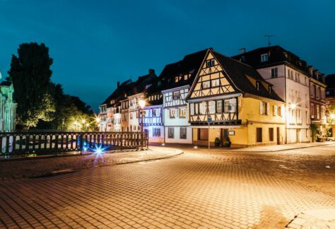 Scenic night view of traditional Alsatian houses in Colmar, France, beautifully lit and serene.
