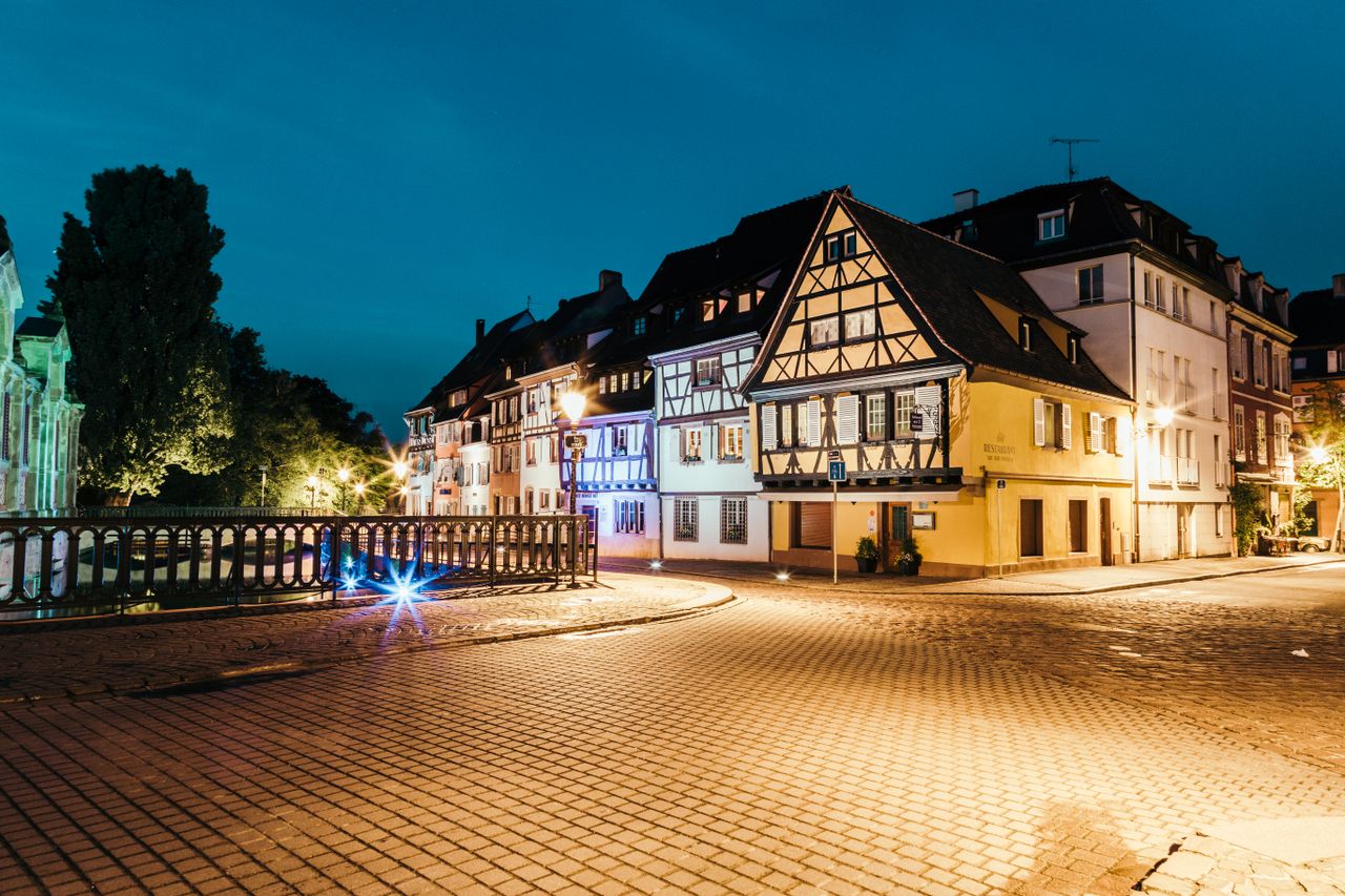 Scenic night view of traditional Alsatian houses in Colmar, France, beautifully lit and serene.
